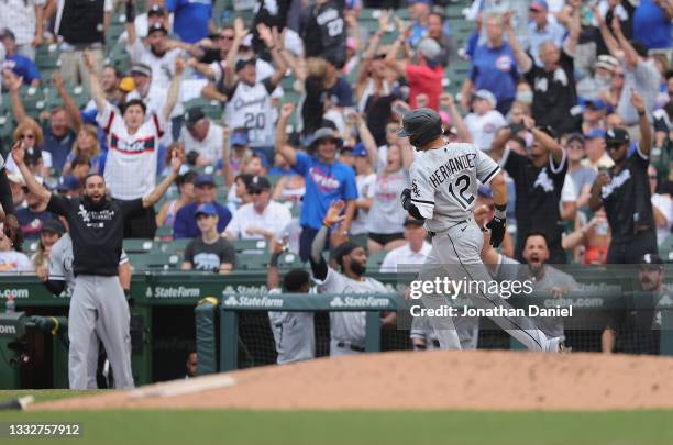 Cesar Hernandez of the Chicago White Sox runs the bases as teammates cheer from the dugout after he hit a two run home run in the 8th inning against...