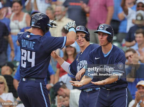 Andrew Romine of the Chicago Cubs celebrates his three run home run in the 8th inning against the Chicago White Sox with Frank Schwindel and Matt...