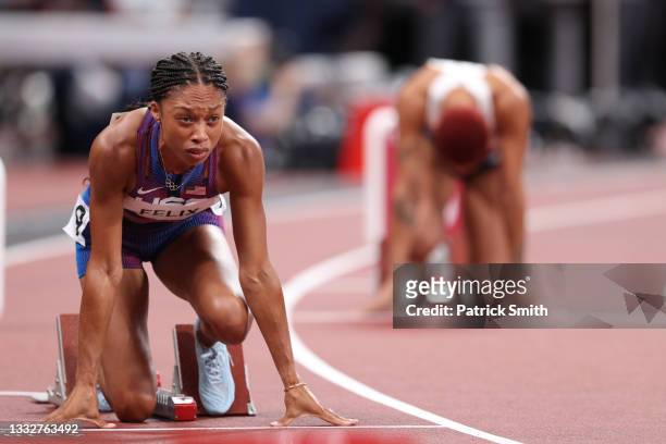 Allyson Felix of Team USA prepares to race by resting in the starting blocks in the Women's 400m on day fourteen of the Tokyo 2020 Olympic Games at...