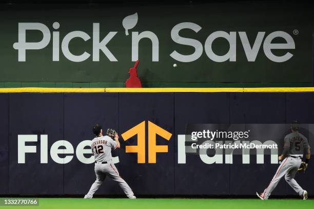 Alex Dickerson and Mike Yastrzemski of the San Francisco Giants are unable to catch a solo home run by Avisail Garcia of the Milwaukee Brewers in the...