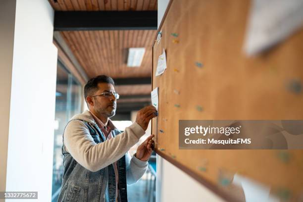 business person working on the bulletin board - pinning bildbanksfoton och bilder