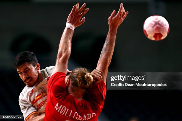 Alex Dujshebaev Dovichebaeva of Team Spain shoots at goal as Henrik Moellgaard of Team Denmark defends during the Men's Semifinal handball match...