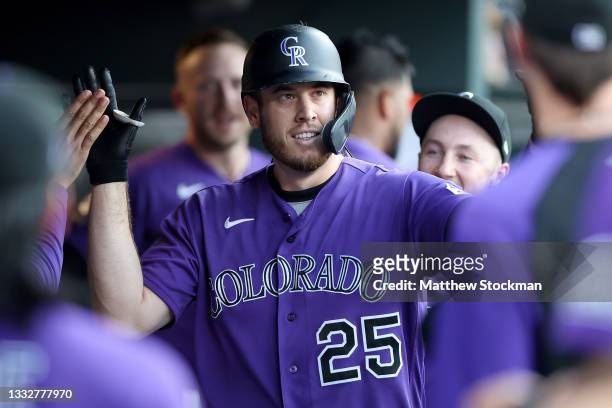 Cron of the Colorado Rockies is congratulated in the dugout after hitting a solo home run against the Miami Marlins in the second inning at Coors...