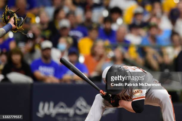 Logan Webb of the San Francisco Giants ducks to avoid a pitch thrown by Corbin Burnes of the Milwaukee Brewers in the fifth inning at American Family...