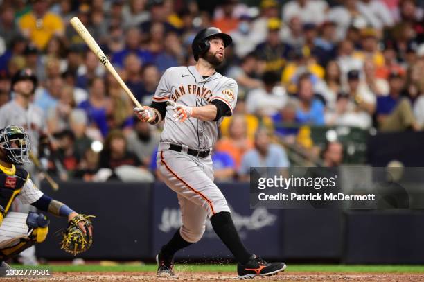 Brandon Belt of the San Francisco Giants hits a solo home run against the Milwaukee Brewers in the sixth inning at American Family Field on August...