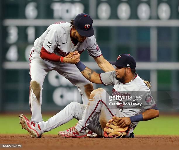 Andrelton Simmons of the Minnesota Twins assists Luis Arraez to fit feet after fielded a ground ball hit by Carlos Correa of the Houston Astros in...