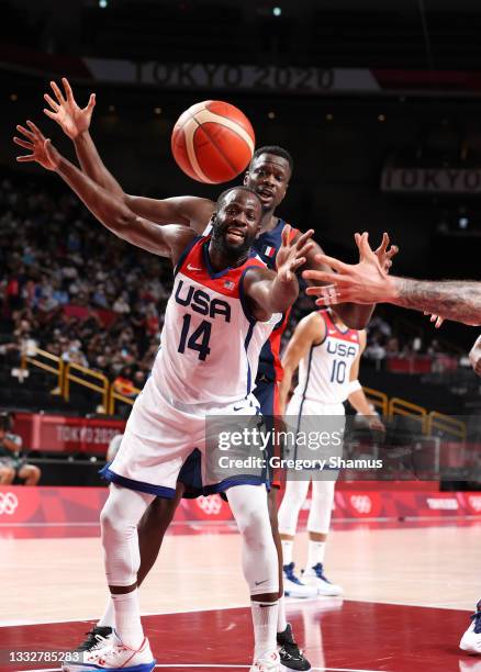 Draymond Green of Team United States and Moustapha Fall of Team France compete for possession of the ball during the first half of a Men's Basketball...