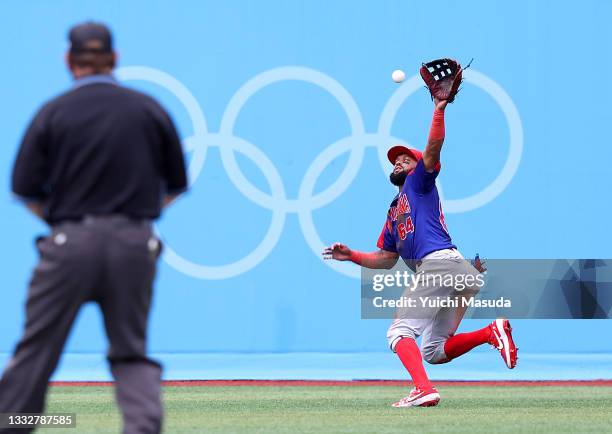 Outfielder Emilio Bonifacio of Team Dominican Republic juggles as Infielder Kyoungmin Hur of Team Republic of Korea hits a single in the first inning...