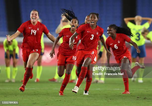 Vanessa Gilles, Ashley Lawrence and Kadeisha Buchanan of Team Canada celebrate following their team's victory in the penalty shoot out in the Women's...