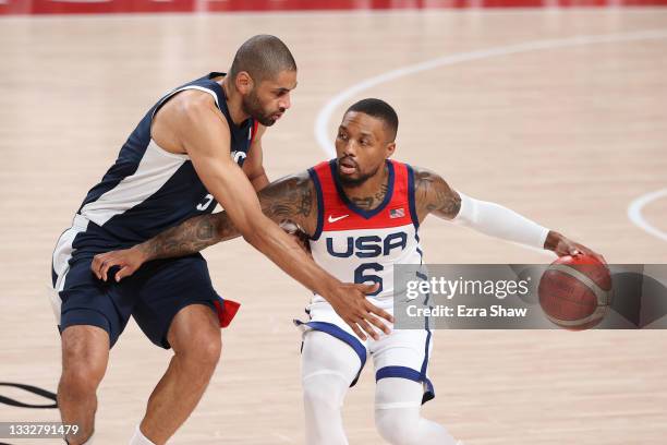 Damian Lillard of Team United States drives to the basket against Nicolas Batum of Team France during the first half of a Men's Basketball Finals...