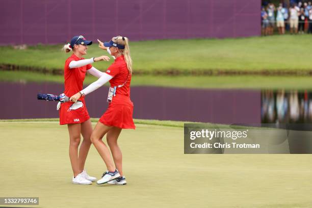 Nelly Korda of Team United States is congratulated by her sister Jessica Korda of Team United States after Nelly secured the gold medal after putting...