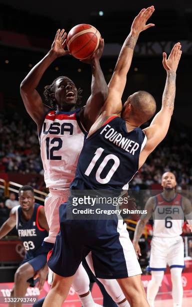 Jrue Holiday of Team United States drives to the basket against Evan Fournier of Team France during the second half of a Men's Basketball Finals game...
