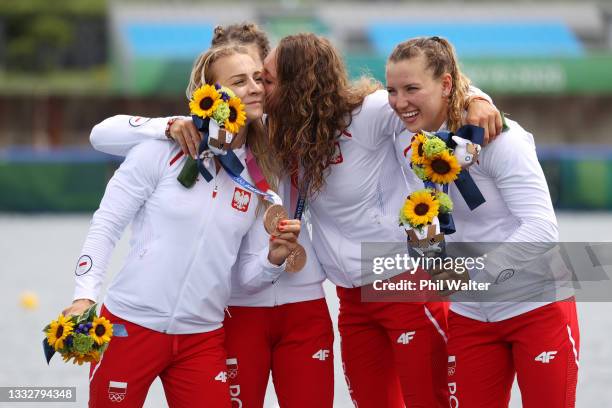 Justyna Iskrzycka, Karolina Naja, Anna Pulawska and Marta Walczykiewicz of Team Poland celebrate at the medal ceremony following the Women's Kayak...