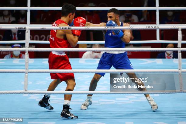 Galal Yafai of Team Great Britain punches Carlo Paalam of Team Philippines during the Men's Fly Final bout between Carlo Paalam of Team Philippines...