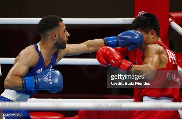 Galal Yafai of Team Great Britain punches Carlo Paalam of Team Philippines during the Men's Fly Final bout between Carlo Paalam of Team Philippines...