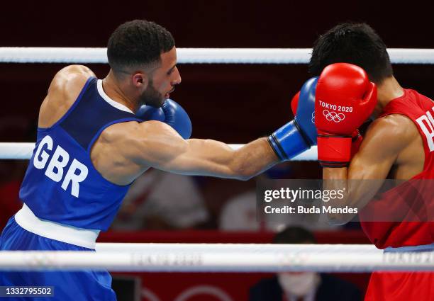 Galal Yafai of Team Great Britain punches Carlo Paalam of Team Philippines during the Men's Fly Final bout between Carlo Paalam of Team Philippines...