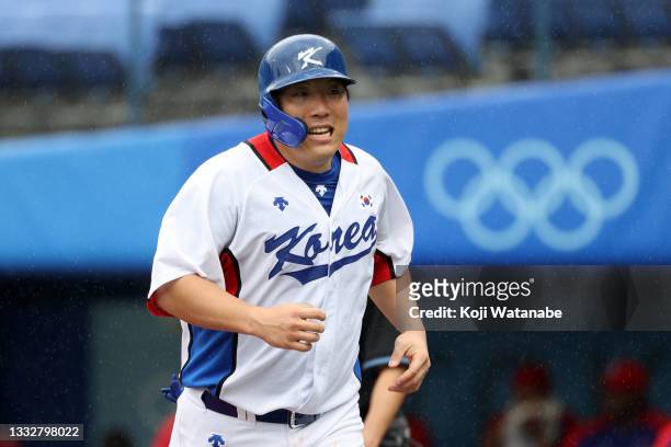 Outfielder Hyunsoo Kim of Team Republic of Korea celebrates scoring a run after the RBI single of Designated hitter Baekho Kang during the bronze...