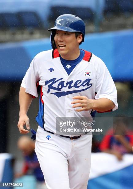 Outfielder Hyunsoo Kim of Team Republic of Korea celebrates scoring a run after the RBI single of Designated hitter Baekho Kang in the fifth inning...