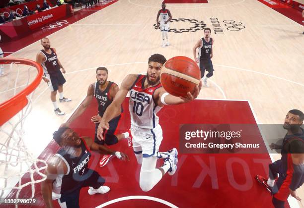Jayson Tatum of Team United States drives to the basket against Guerschon Yabusele and Rudy Gobert of Team France during the first half of a Men's...