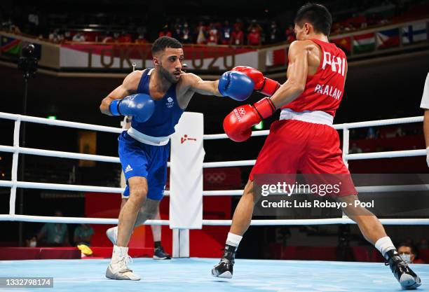 Carlo Paalam of Team Philippines dodges a punch from Galal Yafai of Team Great Britain during the Men's Fly Final bout between Carlo Paalam of Team...