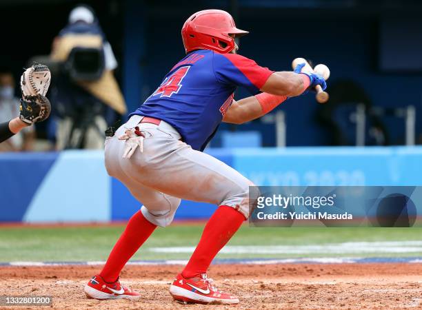 Outfielder Emilio Bonifacio of Team Dominican Republic lays down for a sacrifice bunt in the during the bronze medal game between Dominican Republic...