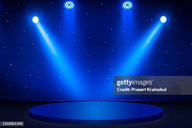 blue round stage under concert lighting , dark background. - downlight stock-fotos und bilder