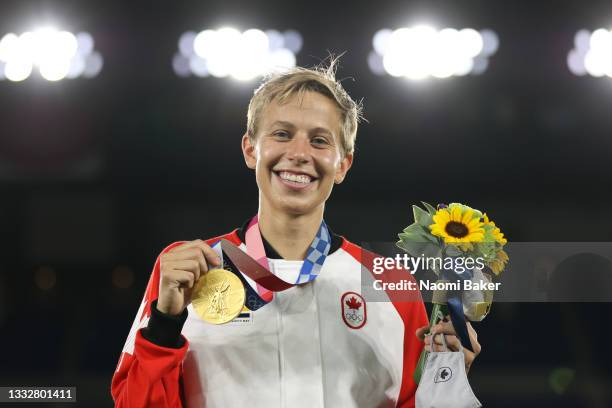 Gold medalist Quinn of Team Canada reacts with their gold medal after becoming the first openly transgender athlete to win Olympic gold during the...