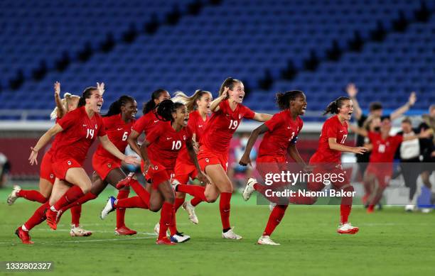 Team Canada celebrate after winning the gold medal after winning the penalty shoot out during the Gold Medal Match Women's Football match between...