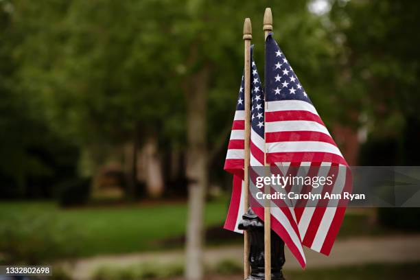 american flags outside home in residential neighborhood - national 911 flag stock-fotos und bilder