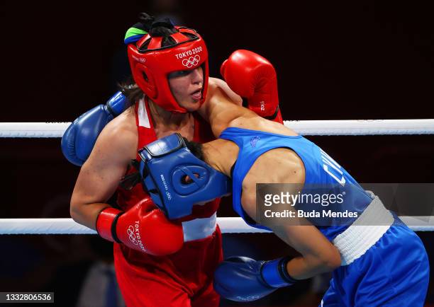 Busenaz Surmeneli of Team Turkey and Hong Gu of Team China tangle during the Women's Welter Final bout between Busenaz Surmeneli of Team Turkey and...