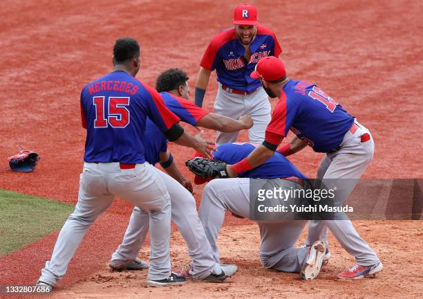 Players of Team Dominican Republic celebrate winning the bronze after their 10-6 victory in the bronze medal game between Dominican Republic and...