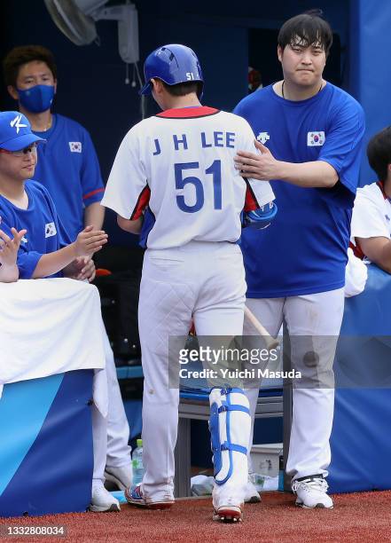 Outfielder Jung Hoo Lee of Team Republic of Korea is consoled by his team mates after striking out during the bronze medal game between Dominican...