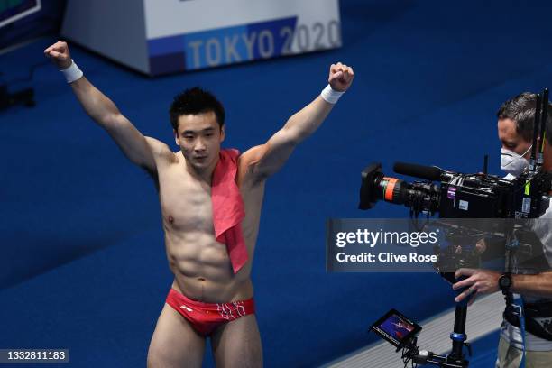 Yuan Cao of Team China celebrates after winning the gold medal in the Men's 10m Platform Final on day fifteen of the Tokyo 2020 Olympic Games at...