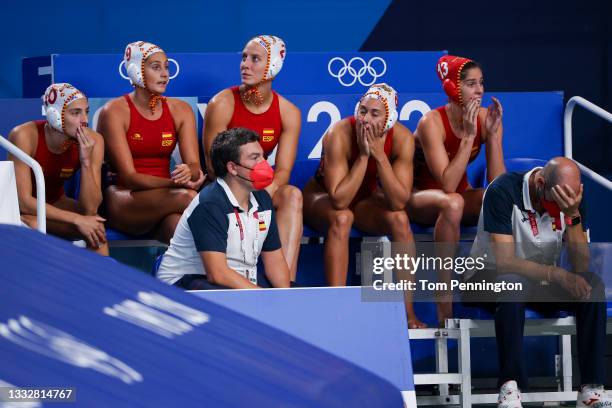 Team Spain players and coaching staff look on in disappointment from the bench during the Women's Gold Medal match between Spain and the United...