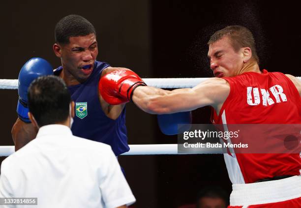 Herbert Sousa of Team Brazil punches Oleksandr Khyzhniak of Team Ukraine during the Men's Middle Final bout between Oleksandr Khyzhniak of Team...