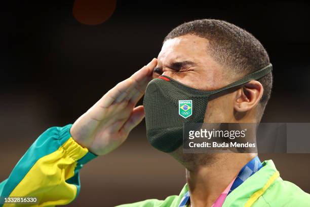 Herbert Sousa of Team Brazil reacts to winning a gold medal during the medal ceremony for the Men's Middle on day fifteen of the Tokyo 2020 Olympic...