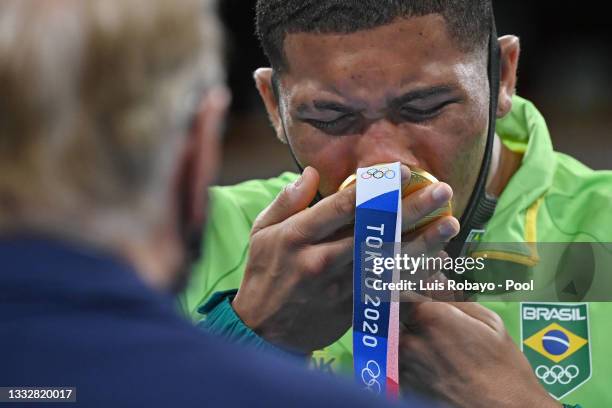 Herbert Sousa of Team Brazil reacts kissing his gold medal during the medal ceremony for the Men's Middle on day fifteen of the Tokyo 2020 Olympic...