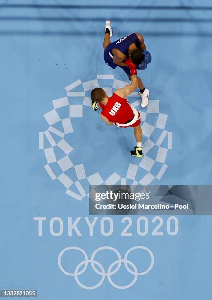 Oleksandr Khyzhniak of Team Ukraine punches Herbert Sousa of Team Brazil during the Men's Middle Final bout between Oleksandr Khyzhniak of Team...