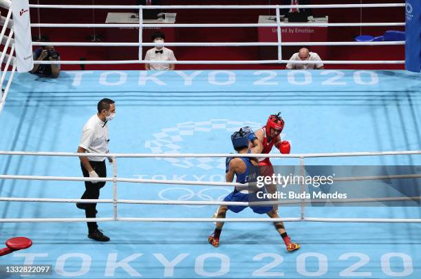 Busenaz Surmeneli of Team Turkey punches Hong Gu of Team China during the Women's Welter Final bout between Busenaz Surmeneli of Team Turkey and Hong...