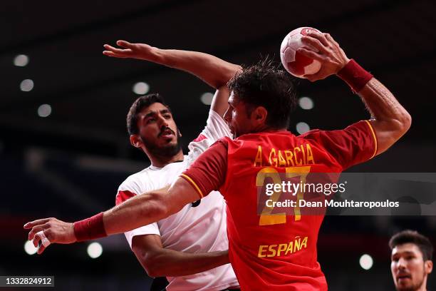 Antonio Garcia Robledo of Team Spain shoots at goal as Yahia Omar of Team Egypt defends during the Men's Bronze Medal handball match between Egypt...
