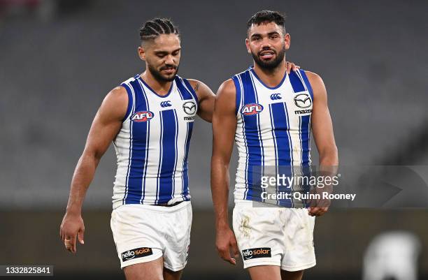 Aaron Hall and Tarryn Thomas of the Kangaroos look dejected after losing the round 21 AFL match between Richmond Tigers and North Melbourne Kangaroos...