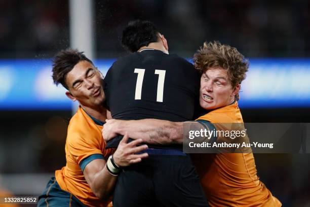 Jordan Petaia and Michael Hooper of the Wallabies make a tackle on Rieko Ioane of the All Blacks during the Rugby Championship and Bledisloe Cup...