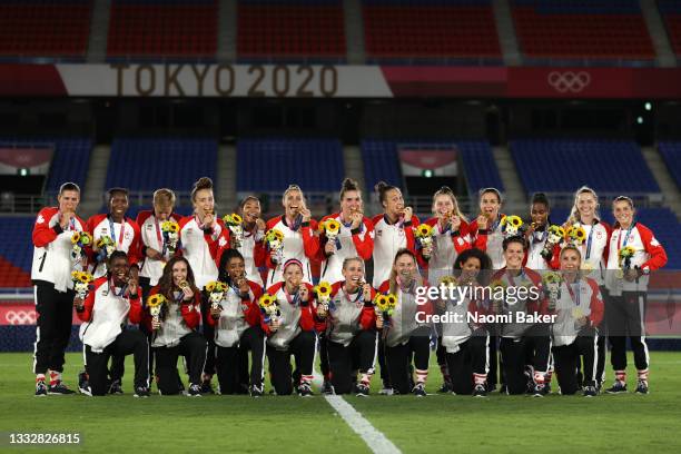 Team Canada celebrate winning the gold medal during the medal ceremony during the Gold Medal Match Women's Football match between Canada and Sweden...