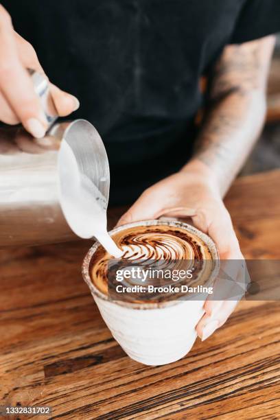 barista pouring coffee with forth art - latte art ストックフォトと画像