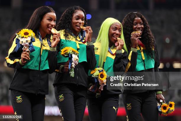 Gold medal winners Briana Williams, Elaine Thompson-Herah, Shelly-Ann Fraser-Pryce and Shericka Jackson of Team Jamaica stand on the podium during...