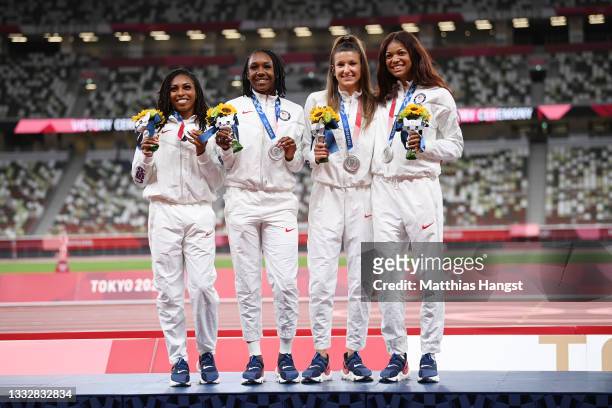 Javianne Oliver, Teahna Daniels, Jenna Prandini and Gabrielle Thomas of Team United States stand on the podium during the medal ceremony for the...