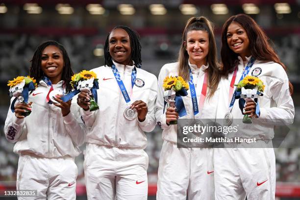 Javianne Oliver, Teahna Daniels, Jenna Prandini and Gabrielle Thomas of Team United States stand on the podium during the medal ceremony for the...