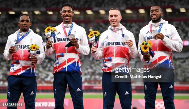 Silver medal winners CJ Ujah, Zharnel Hughes, Richard Kilty and Nethaneel Mitchell-Blake of Team Great Britain stand on the podium during the medal...