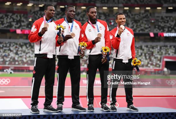Aaron Brown, Jerome Blake, Brendon Rodney and Andre De Grasse of Team Canada stand on the podium during the medal ceremony for the Men's 4 x 100m...