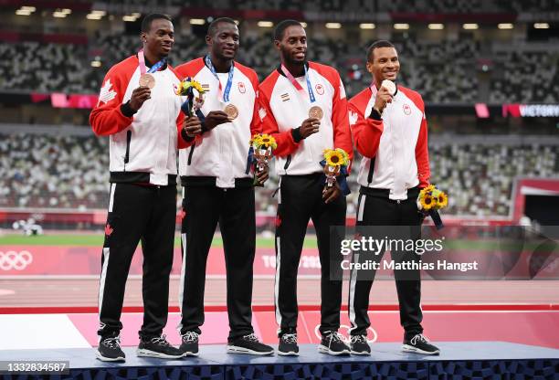 Bronze medal winners Aaron Brown, Jerome Blake, Brendon Rodney and Andre De Grasse of Team Canada stand on the podium during the medal ceremony for...